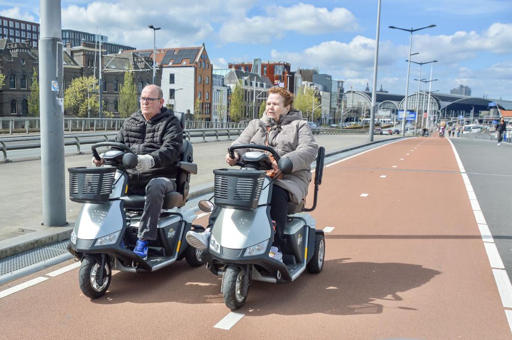 People of all ages and abilities ride a wide variety of two- and three wheeled mobility devices along protected bike infrastructure in the Netherlands.