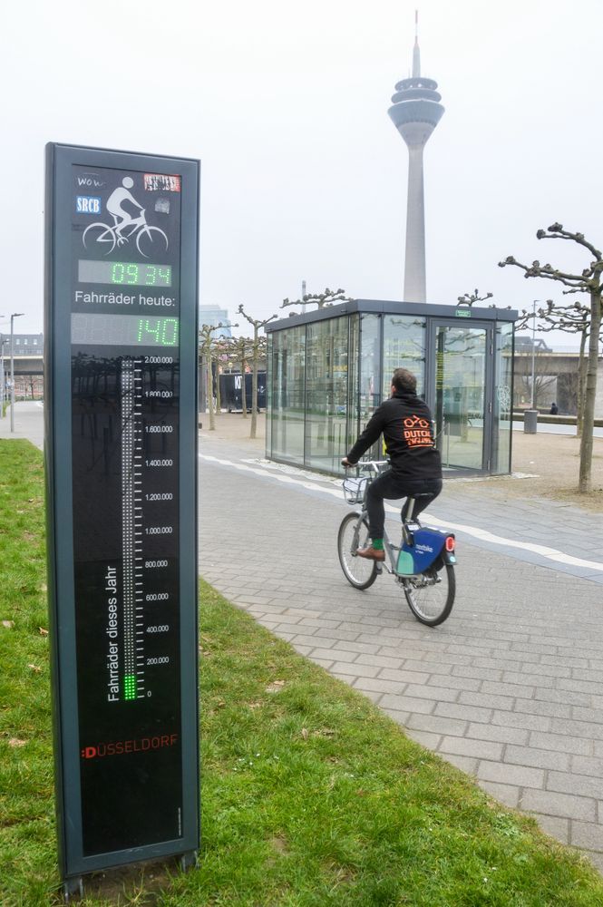 Cyclist riding past bike counter in Düsseldorf