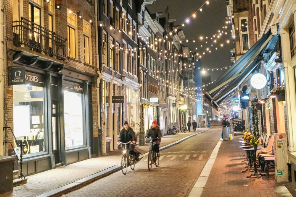 People cycling at night on Dutch Street