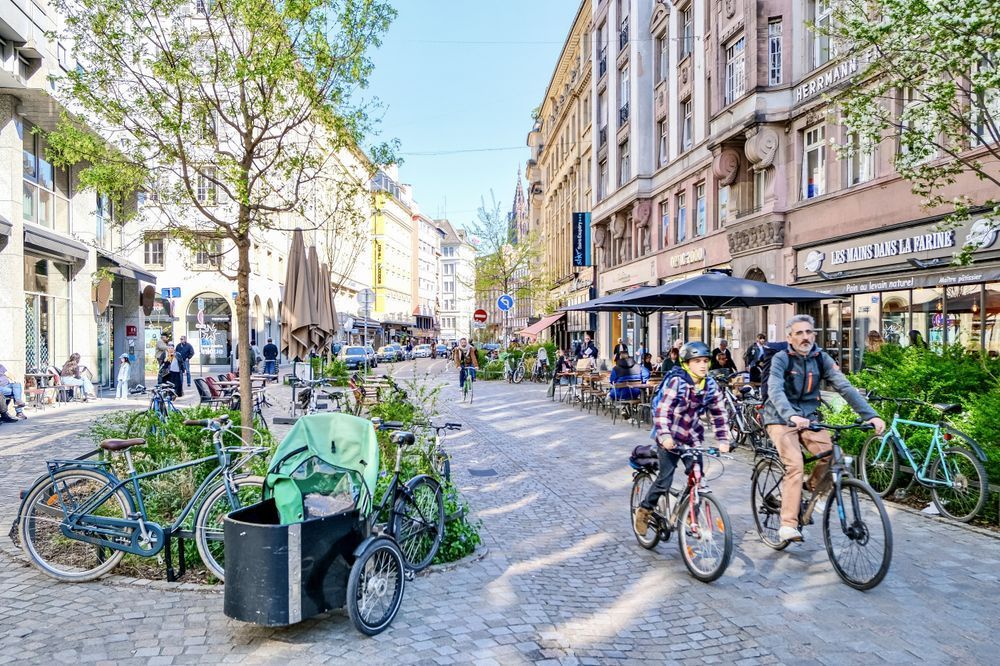 Father and son riding along cobbled street