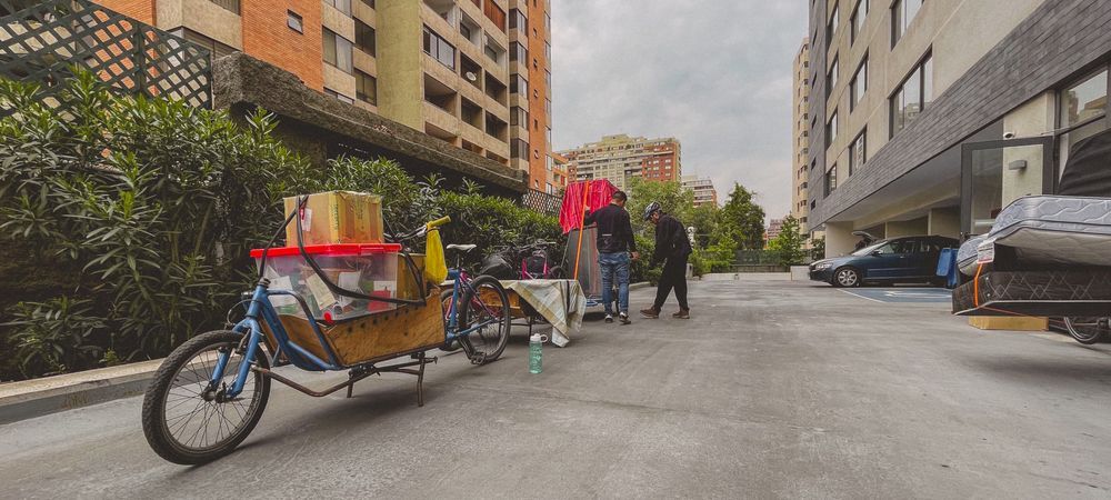 People riding cargo bikes with furniture loaded on