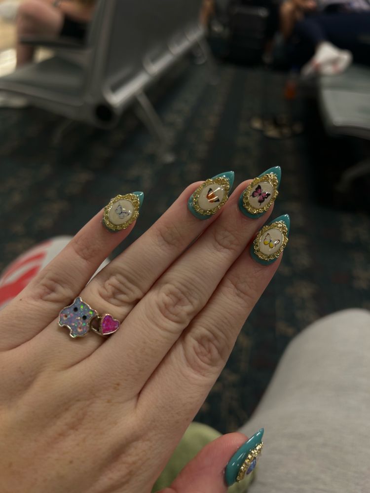 a hand with taxidermy butterfly inspired press on nails