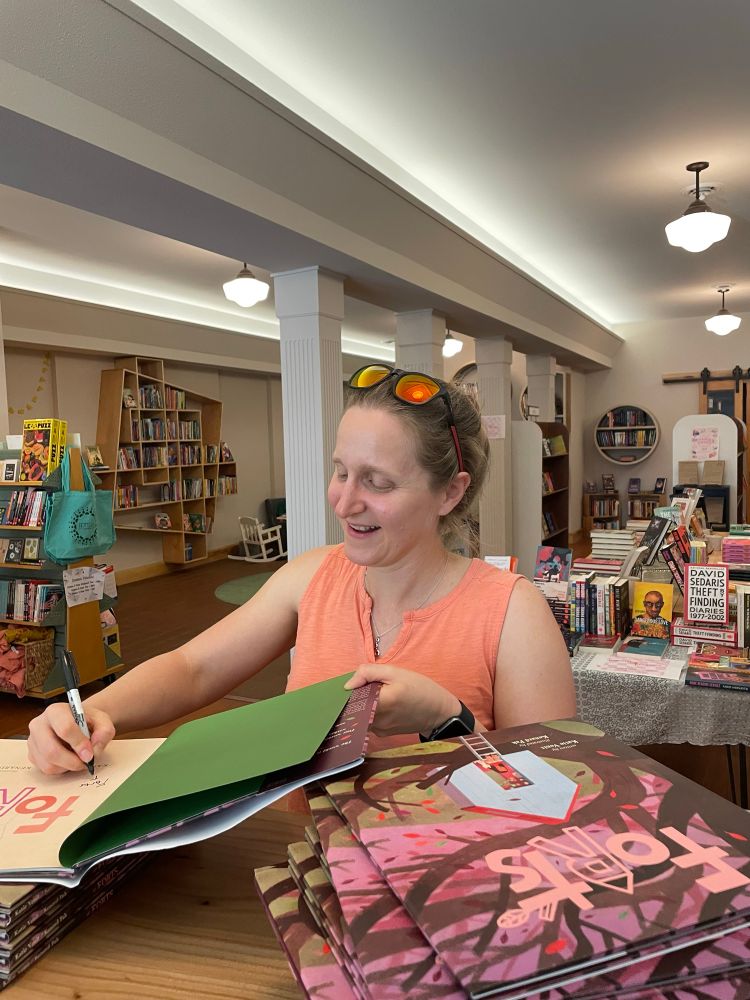 Katie Venit, the author, signing copies of Forts in a bookstore.