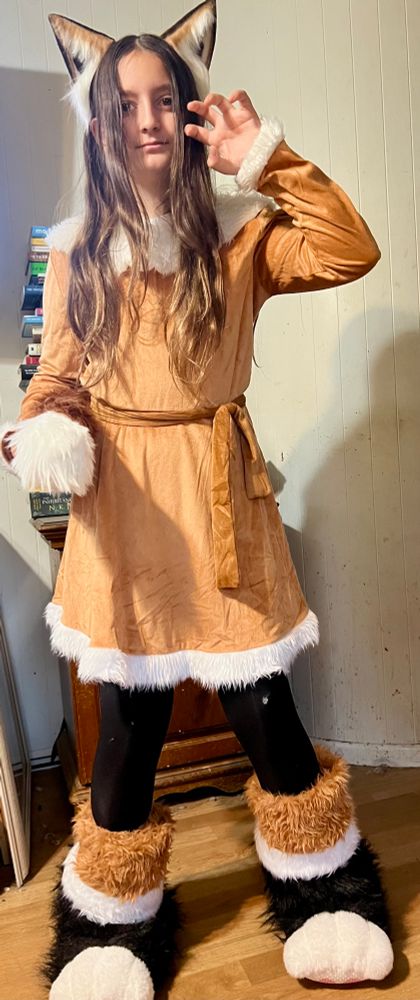 Photo, from the front, of a girl dressed as a fox for Halloween.