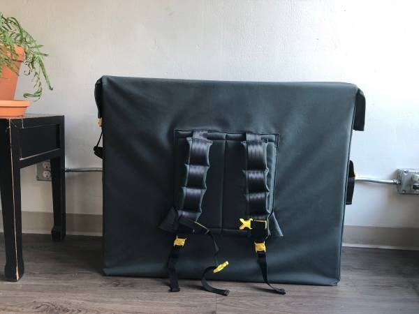 Trash Messenger Bags' "Space Junk" pictured: a large rectangular backpack used to carry and ship a disassembled bicycle on airplanes and transit to skirt bicycle shipping fees.