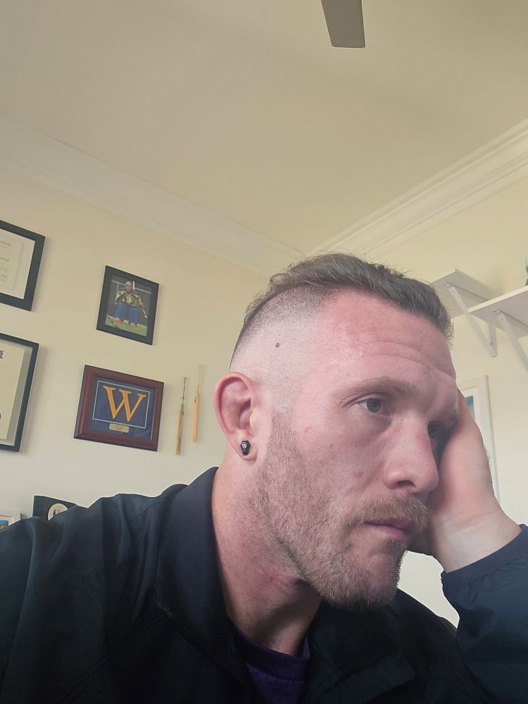 A selfie of me with my combed back high fade.