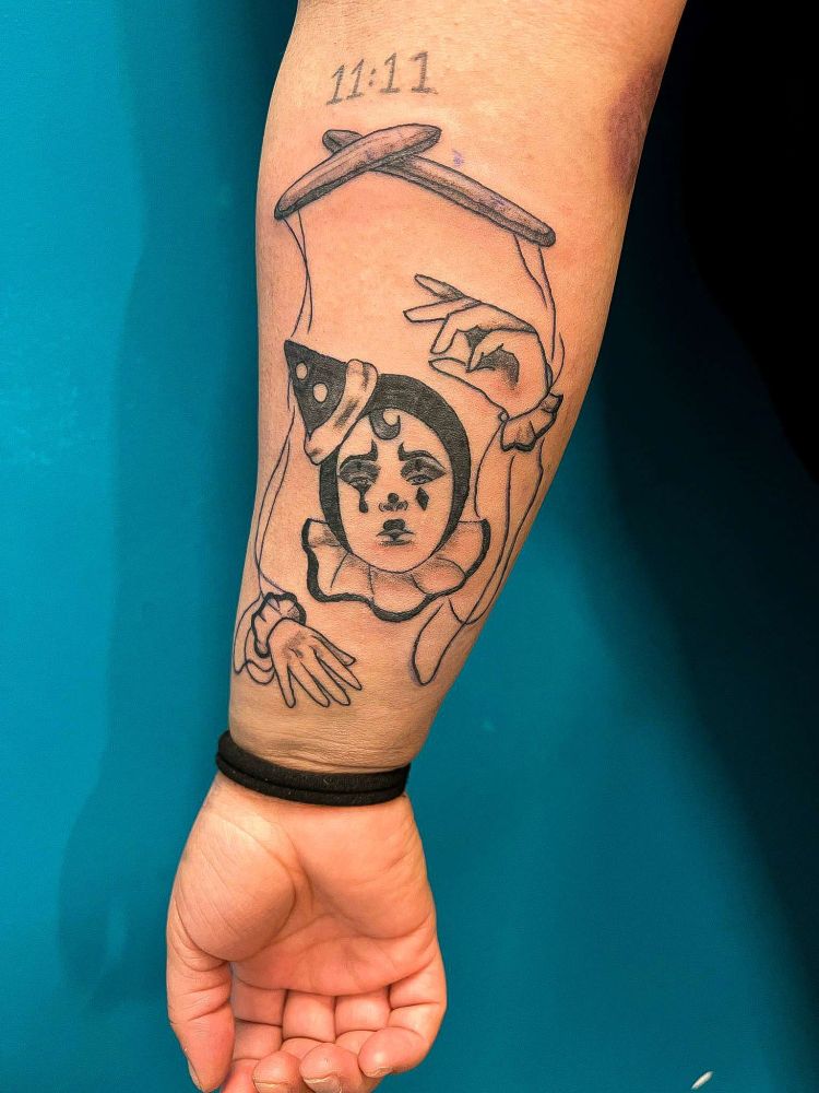 Harlequinn/marionette tattoo.
