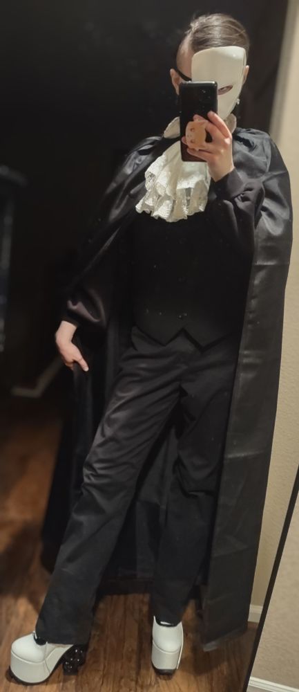 A full body of me, showing off my costume. The outfit is all black, save for the white jabot and tuxedo platform boots (truly Operetta's shoes from Monster High, sold by YRU Shoes. The heel is a g-clef btw, super cool).