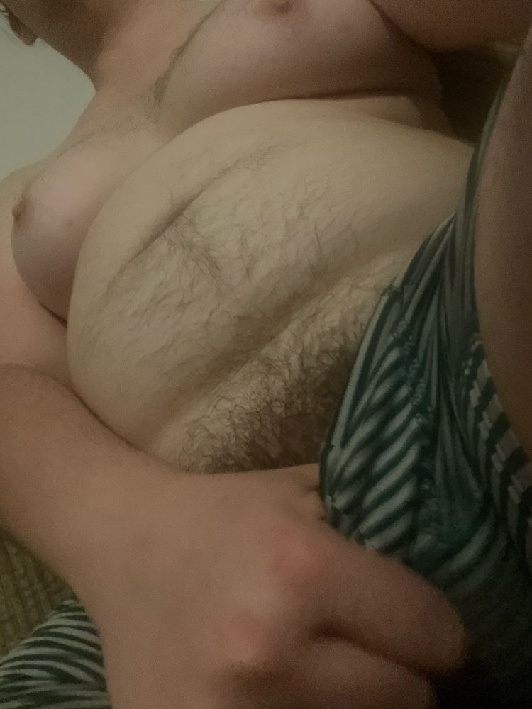 A white trans person, seen from their green-and-white striped boxers to their neck. The viewer’s face is stuffed in the subject’s bulge.