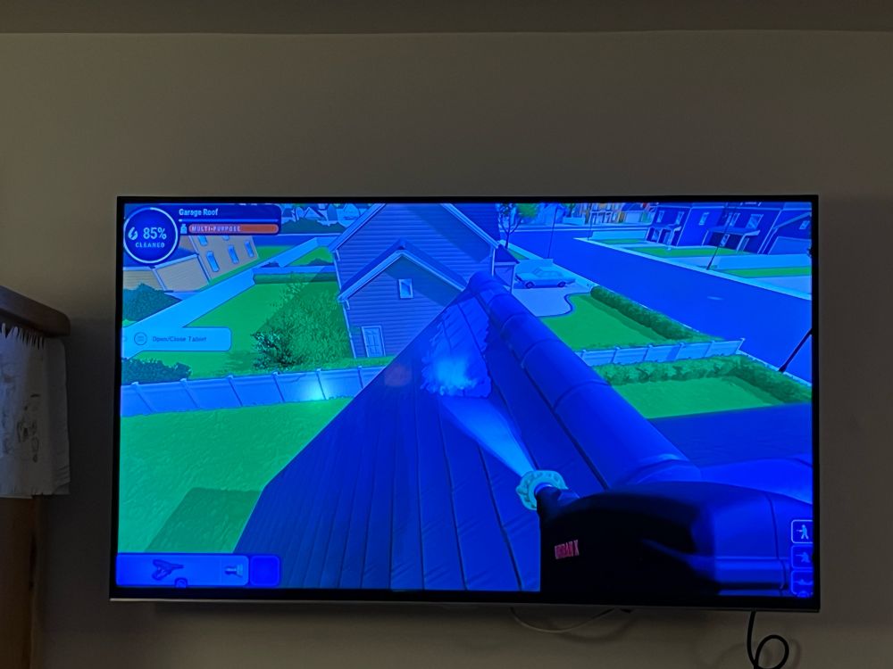 View of TV screen showing PowerWash simulator game
