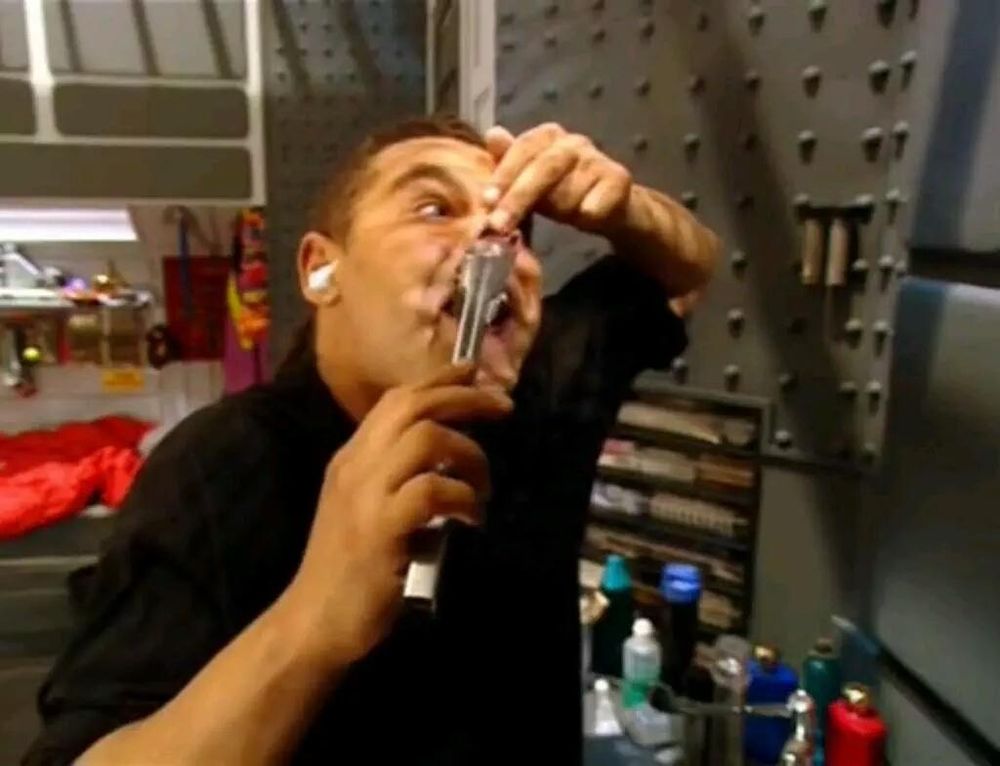 Red Dwarf - Dave Lister, steel tongs in hand, carefully grasping nose hair with tongs