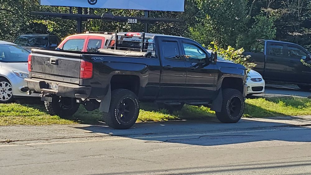 A truck parked on the sidewalk