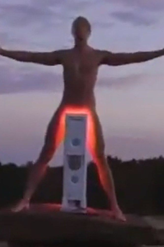 A guy doing some testicle tanning with whatever oddball machine was made for that.