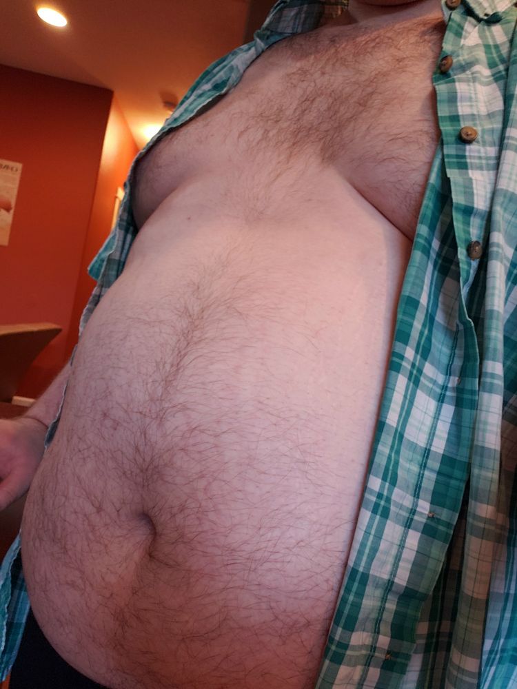 Wearing a green and white plaid button up, open and showing off my tummy