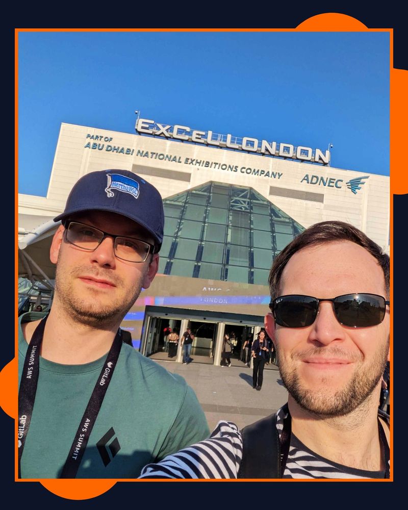 A navy and orange graphic displaying a picture of Tom and James from Hive IT smiling infront of the London Excel building.
