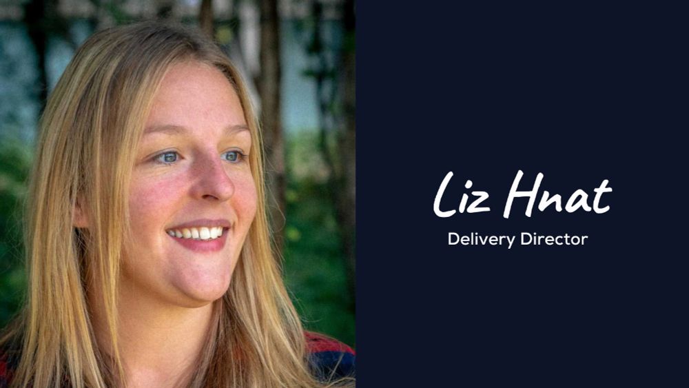 A navy graphic displaying Liz Hnat stood in front of green foliage smiling. Accompanied by the text, 'Liz Hhat Delivery Director. 