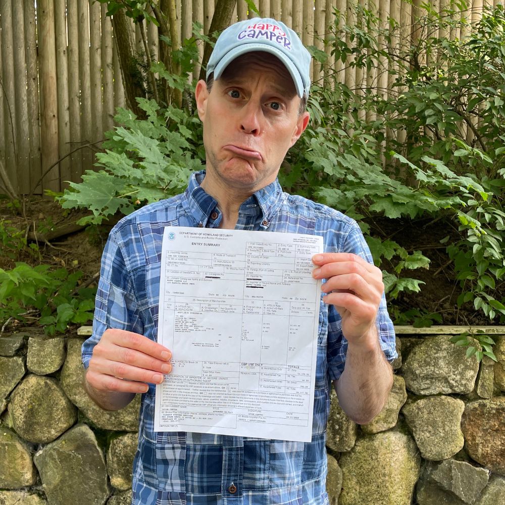 Jason from Happy Camper holding a tariff bill