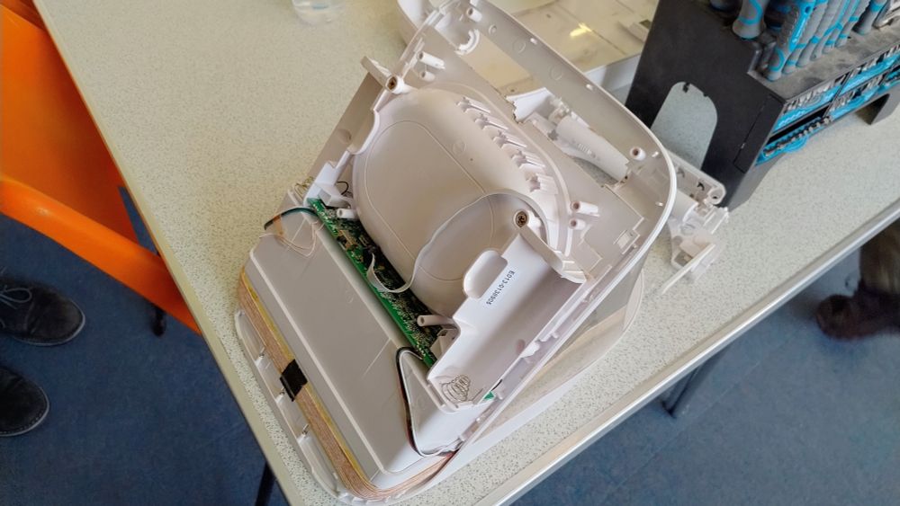 A large white plastic box with complicated internals.