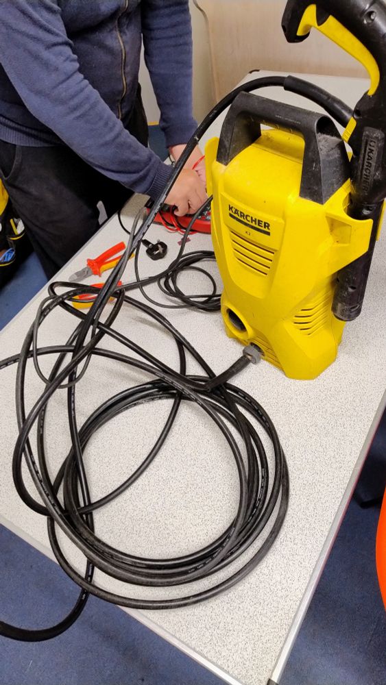A bright yellow Karcher pressure washer.