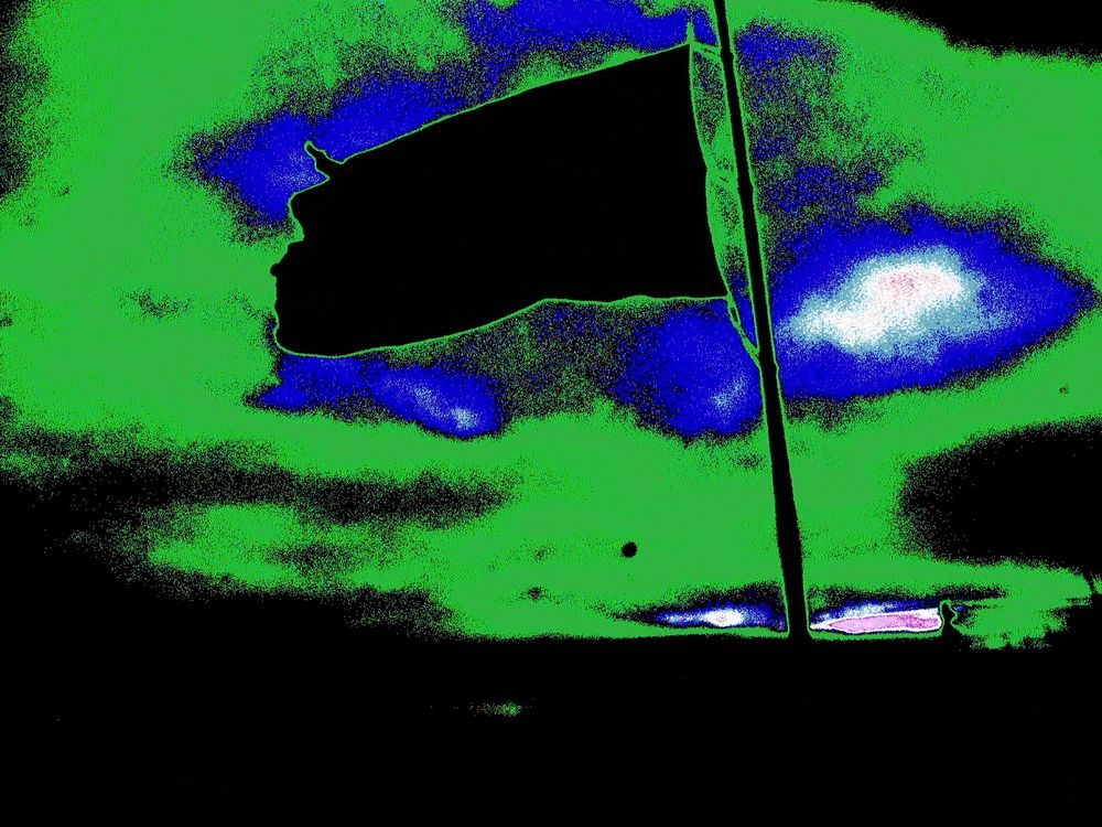 Circuit-bent photograph of a large American flag.
