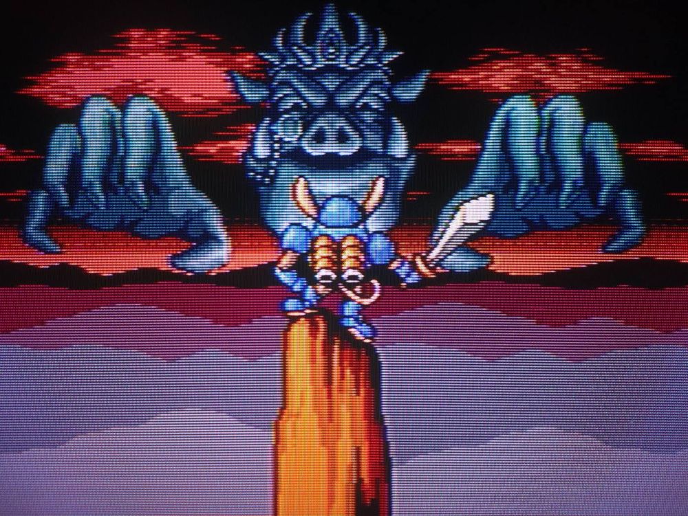 Sparkster, with sword in hand, takes a stand against a giant spectral Emperor Devligus Devotindos
-
Game: Rocket Knight Adventures
Developer: Konami 
Platform: Sega Genesis
⚪🔴🟡