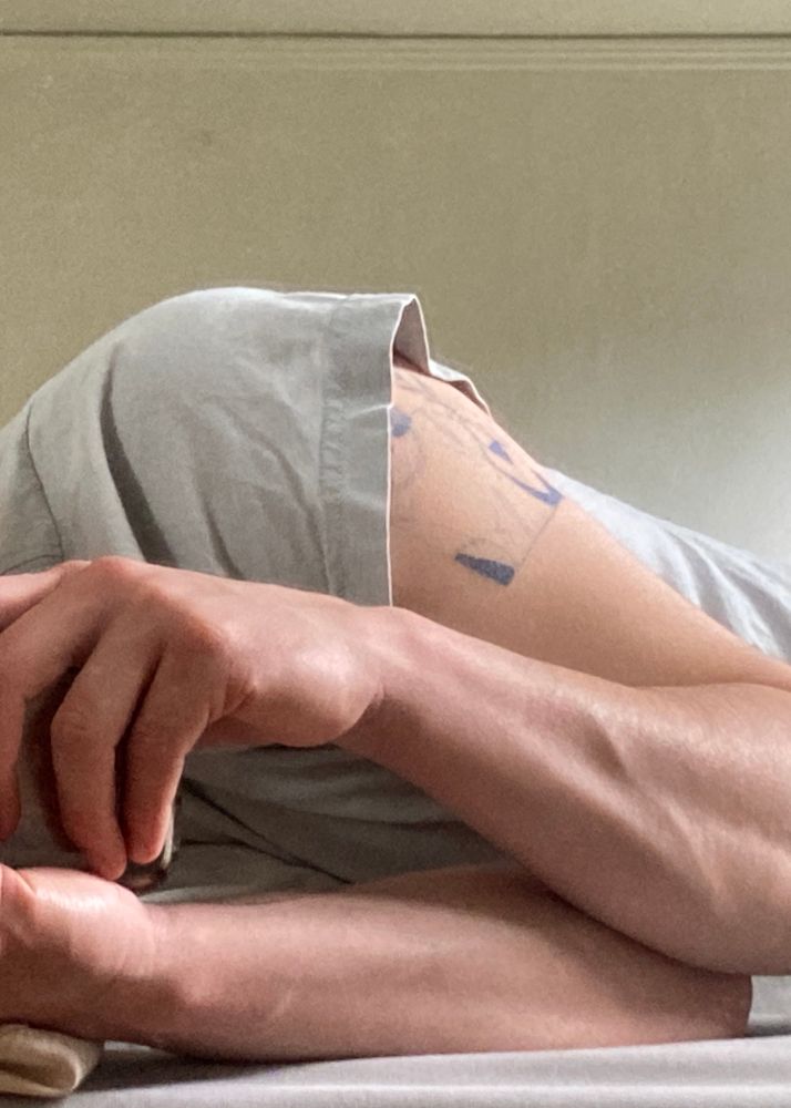 Wearing a ashy blue cropped t-shirt. My hands and arms look cool here, one of my veins is popping out of my forearm. I’m laying on my side while pointing the camera towards my mirror that stands at the foot end of my bed. Lotta sunlight coming into my room around 3:50pm