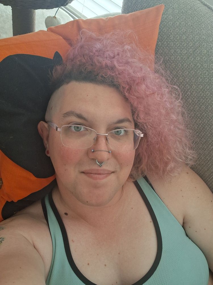 Pink haired tranny in a teal sports bra