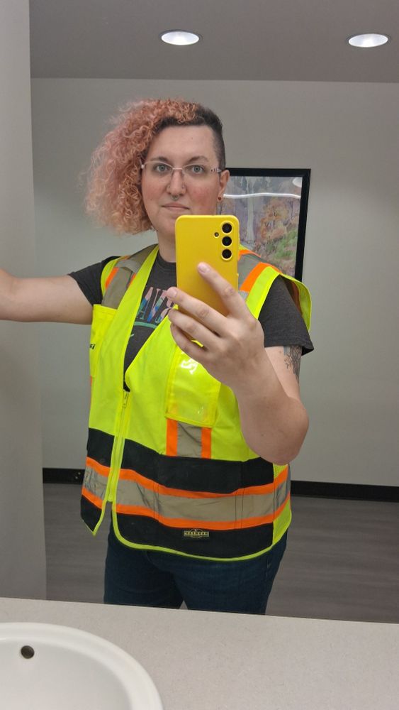 Me in safety vest taking a pic in bathroom mirror