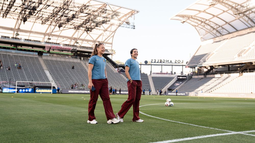 Janni and Lauren walking on the field at BMO Stadium