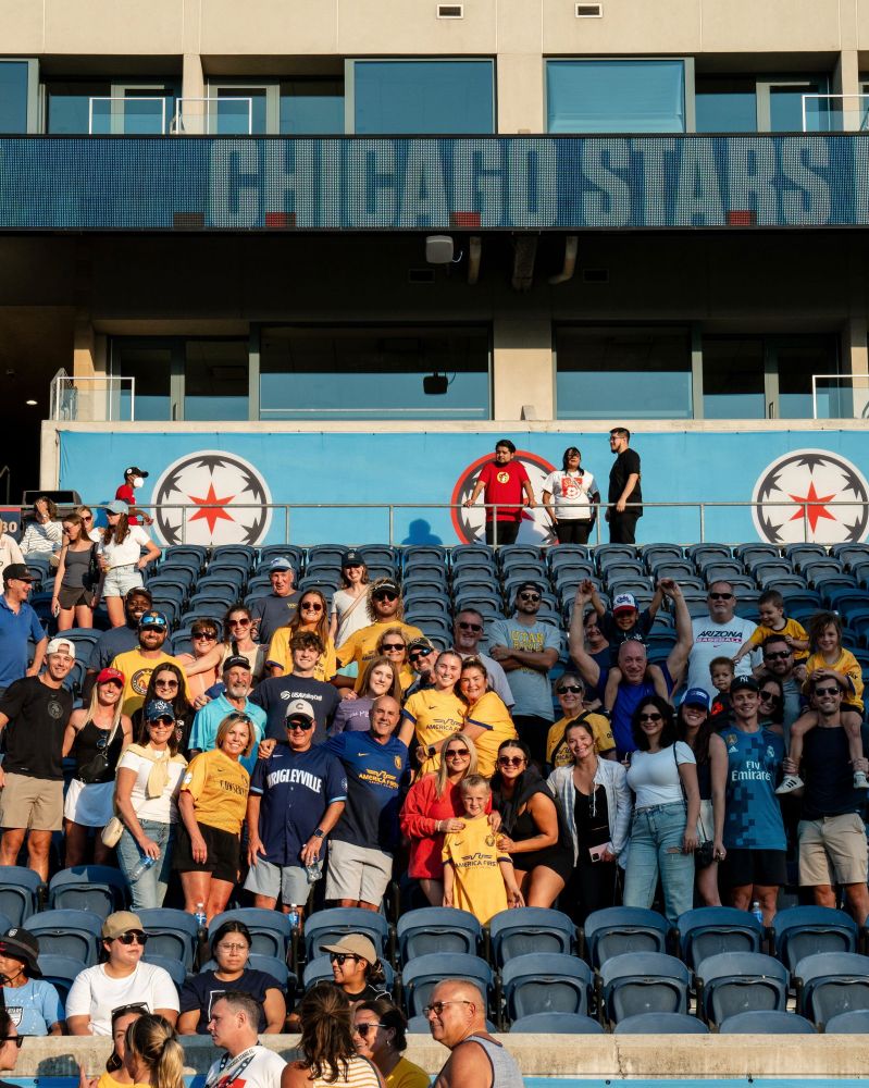 A photo of Kate in the stands post game at CHIvUTA with a big group of her family and friends