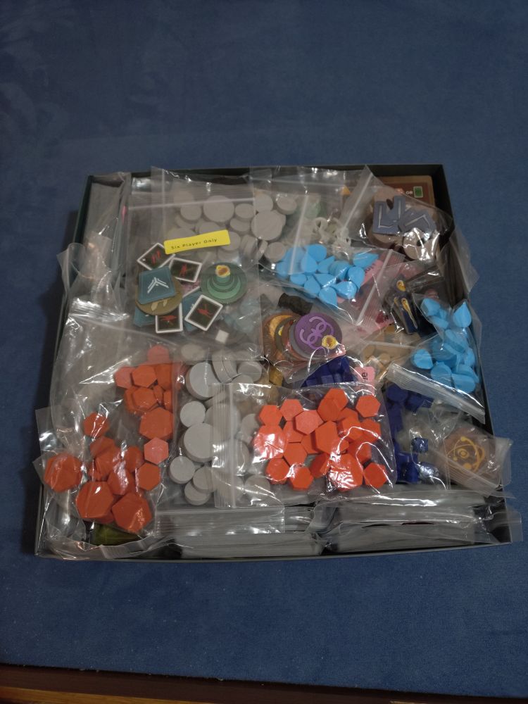 A box that is bursting at the seams with various components in baggies