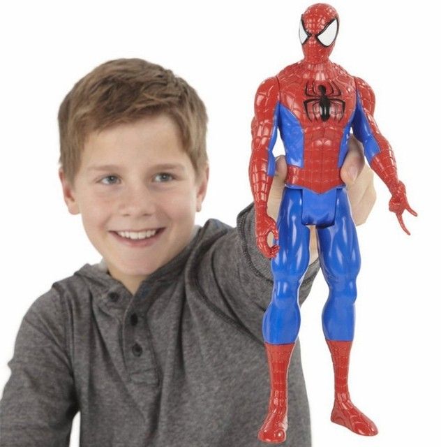 A child holding up a large Spider-man doll