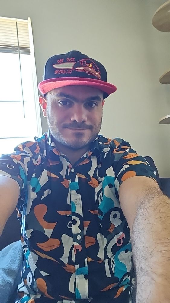 Me wearing a bird button-up and a bird hat.