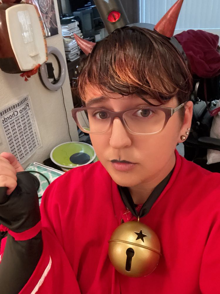 Kota in a cult of the lamb cosplay with a close up selfie 