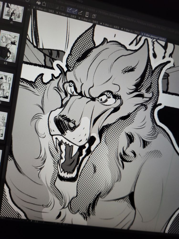 A photo of a Wacom tablet displaying a close-up of a comic page in Clip Studio Paint, depicting an angry werewolf.