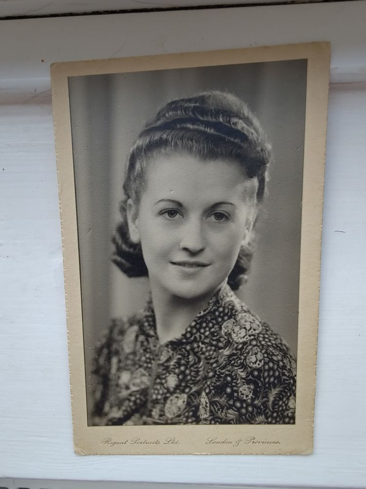Old black and white photo of young woman, head and shoulders shot