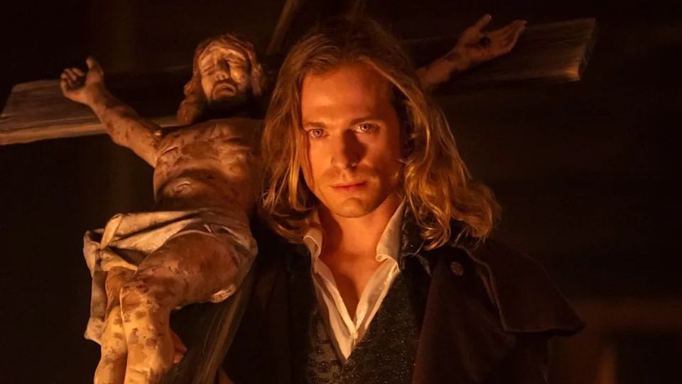 Lestat from Interview with the Vampire AMC holding a large crucifix 