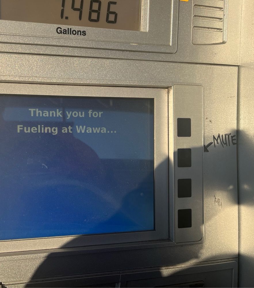 A wawa gas pump screen with a hand drawn arrow, pointing to the second button from top on the right and the word mute.