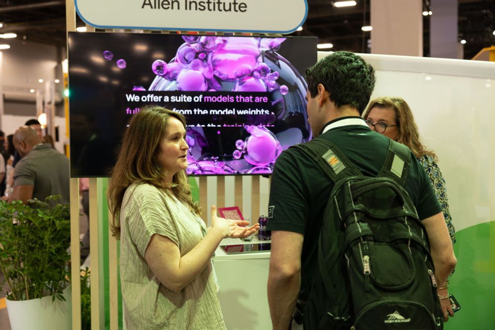 Ai2 COO Sophie Lebrecht talks to visitors at Ai2's booth at Google Cloud Next.
