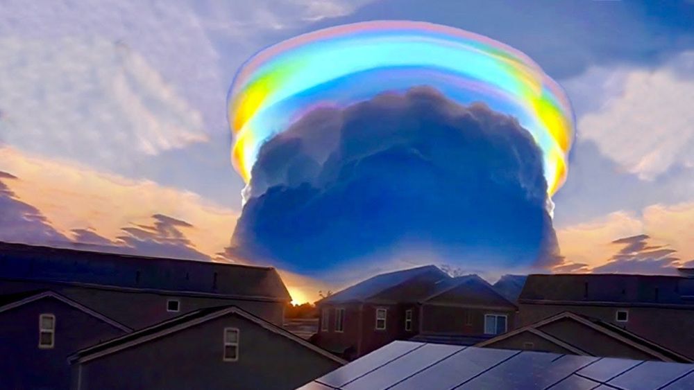 a photograph of a giant pileus cloud with an iridescent halo around the top