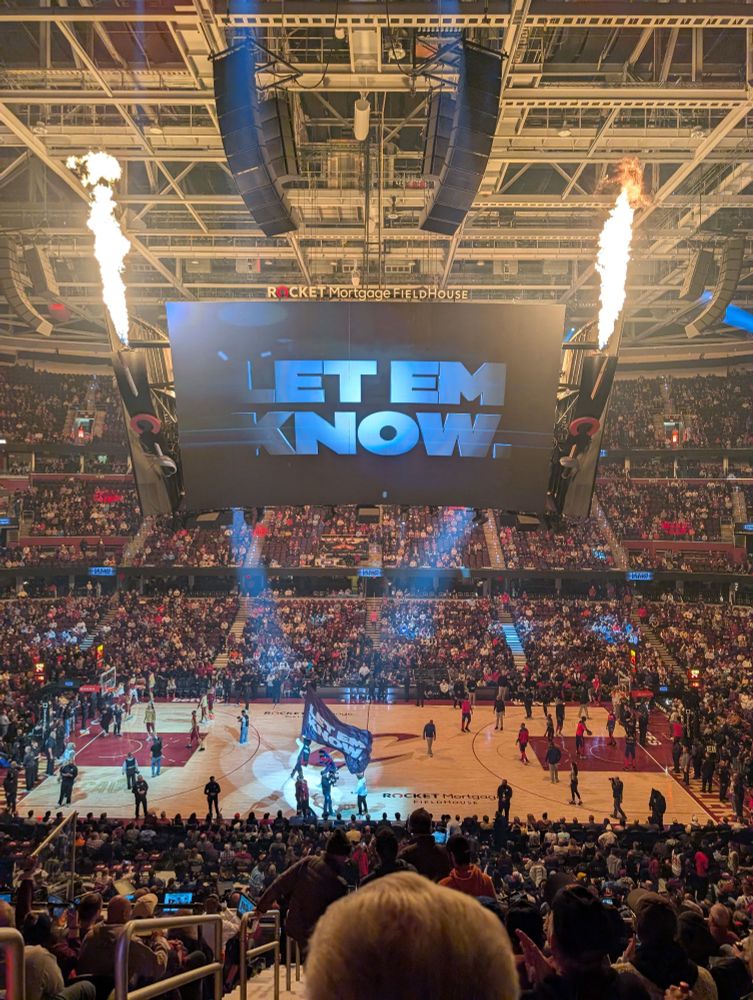 Court and and scoreboard at Cleveland Cavaliers' arena showing "LET EM KNOW."