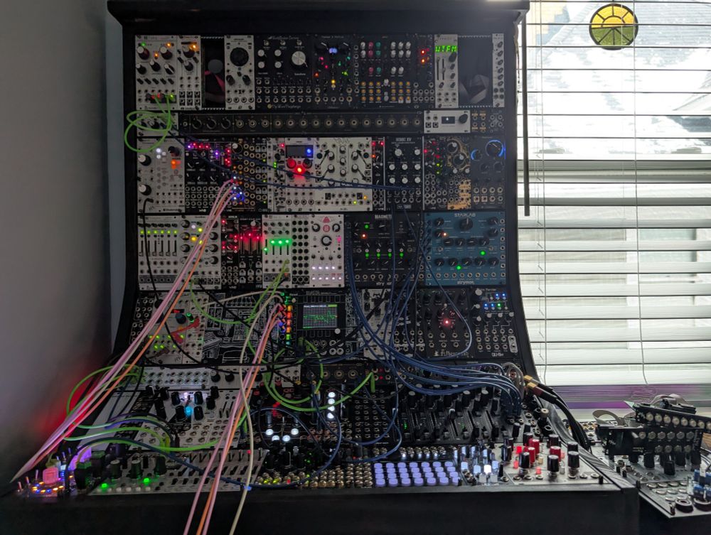 Eurorack synthesizer next to window showing cold, snowy weather outside 