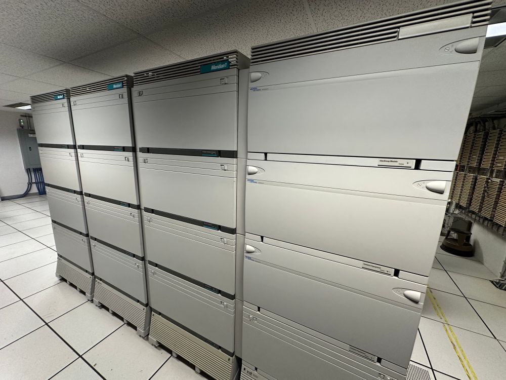 Four Meridian 1 phone cabinets, each the size of a refrigerator.