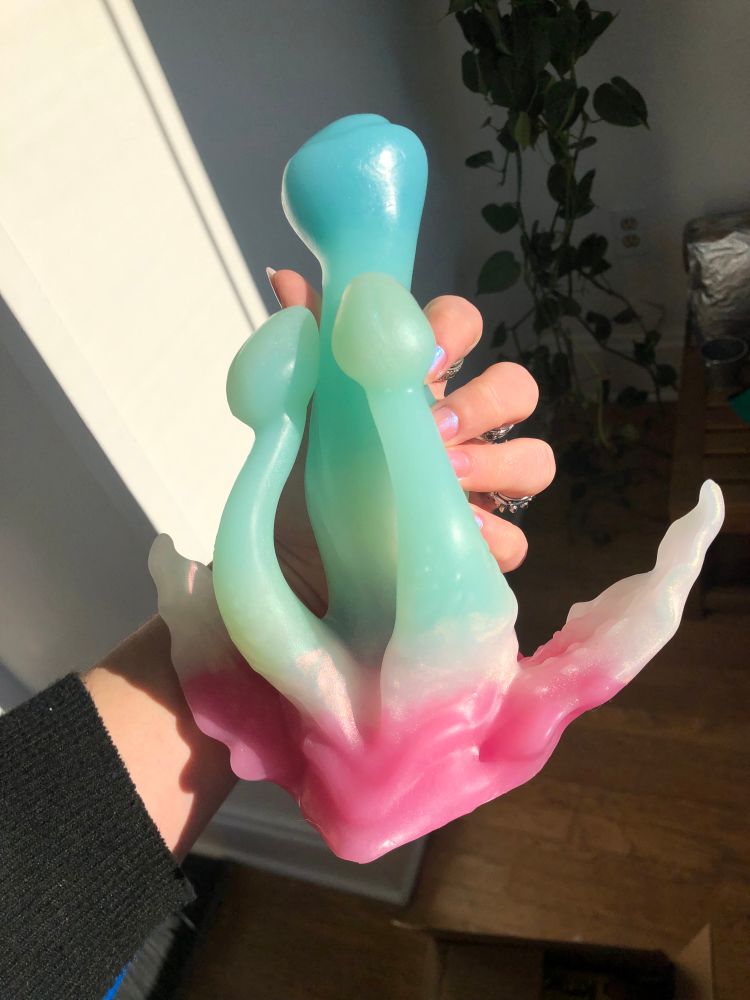 an adult toy made from silicon, in a mix of blues, greens, whites and pinks