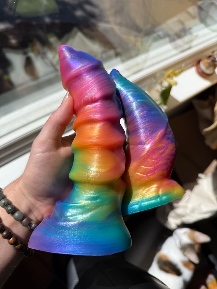 two rainbow silicone toys in my hand