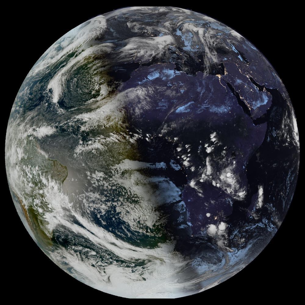 Full disk satellite view of Earth centered on Africa and Europe, with partial views of South America and the Middle East. The satellite image showing Earth from geostationary orbit, captured by EUMETSAT's Meteosat Third Generation (MTG) satellite using the GeoColor RGB composite technique. The image displays both day and night views of Earth, with the daytime portion showing true color representation of land and clouds, while the nighttime portion appears darker with visible city lights. White cloud formations are scattered across the image, particularly along the intertropical convergence zone. The image provides a full disk view of Earth, showing the planet's curvature against a black background.