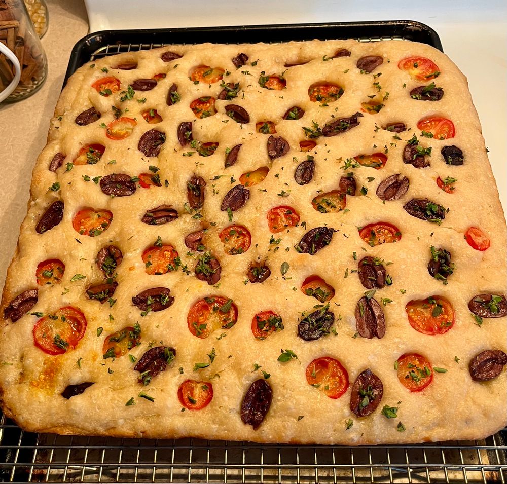 14x14 pan of focaccia topped with cherry tomatoes, olives, and fresh oregano 