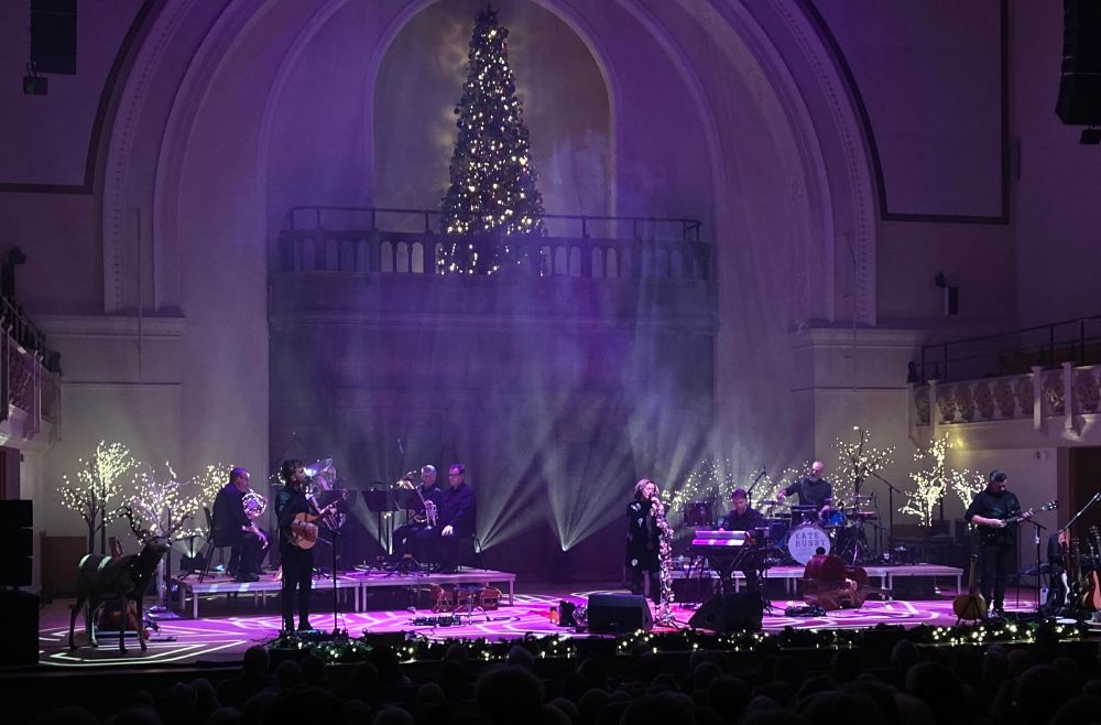 Kate Rusby and her band, plus lots of glitter and lights, and Ruby the Reindeer, on stage.