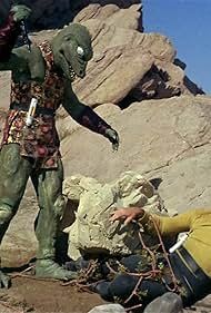 In Star Trek: The Original Series season 1 episode 18 "Arena", Captain James T. Kirk battles a Gorn on a planet surface.