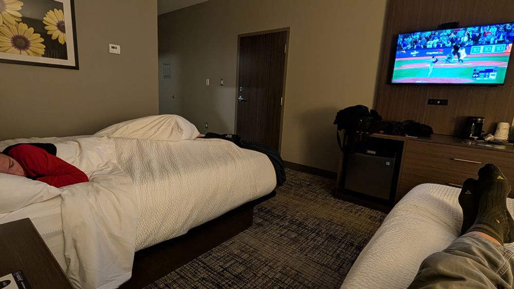 A tired out hockey-playing kid falling asleep in the 10th inning of game 7 of the World Series. 